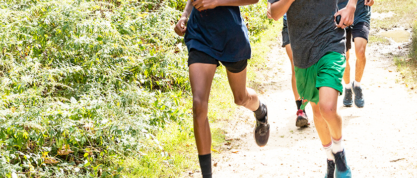 Teens Running on Trail Outdoors