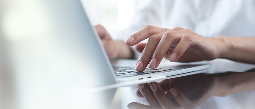 Fingers Typing on Laptop