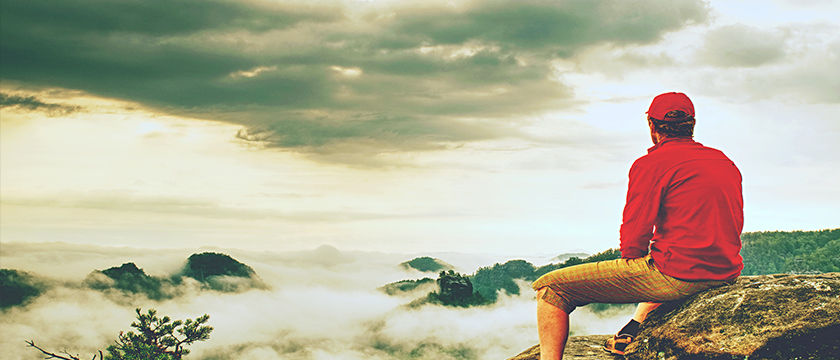 Man Resting on a Ridge During a Hike