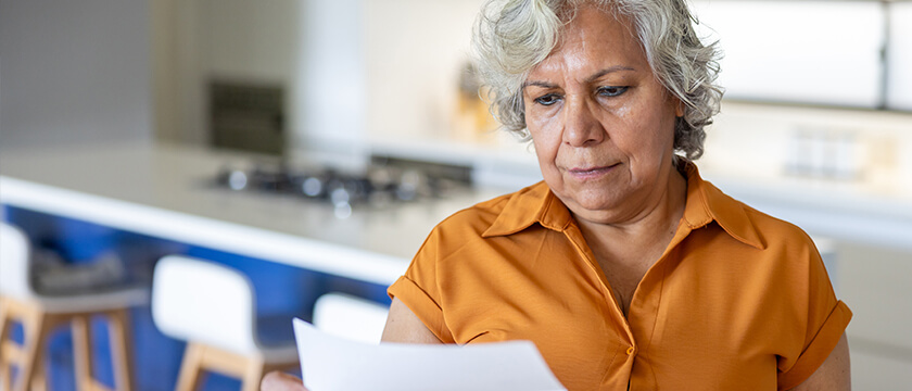 Woman Looking at Sheet of Paper