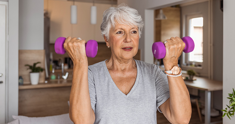 Woman Lifting Purple Weights in Both Arms